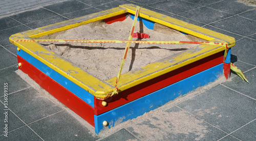 Foto Wooden  sandbox  on childrens playground closed  with stop tape