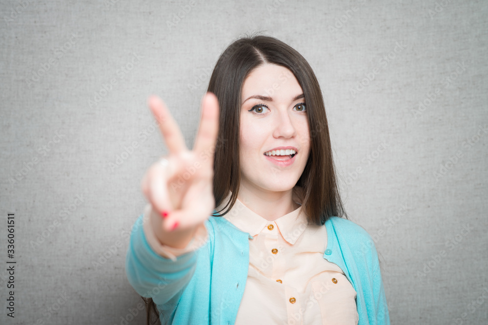 girl showing two fingers girl showing two fingers