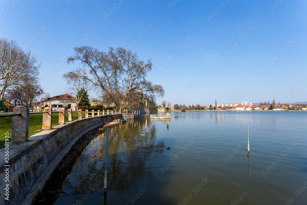 The old lake in Tata, Hungary with the statue of Saint John.
