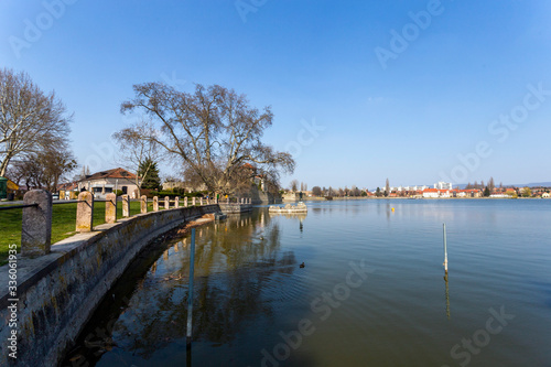 The old lake in Tata, Hungary with the statue of Saint John. © skovalsky