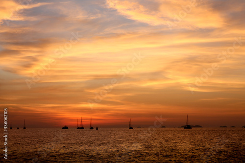 The sun was setting near dusk. See fishing boats See in the distance. © BAKPart