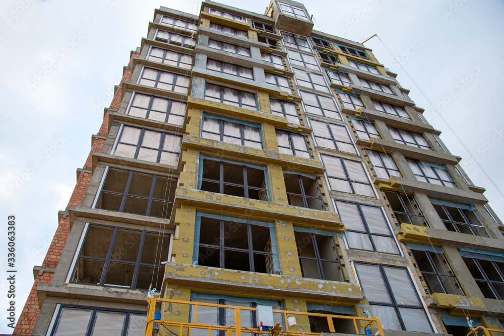 Mineral wool insulation of the facade building on construction site ...