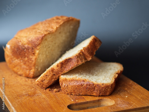 Fresh bread sliced on a wooden board. Homemade bread.