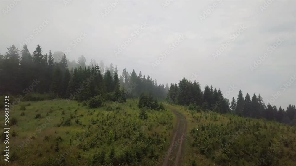 Aerial view of a mountain road that rises during the morning fog Aerial view of a mountain road that rises during the morning fog