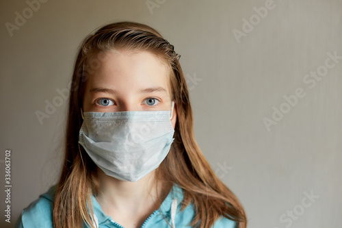 self-isolation and quarantine, portrait of a teenage girl in a medical mask, protection from viruses and diseases