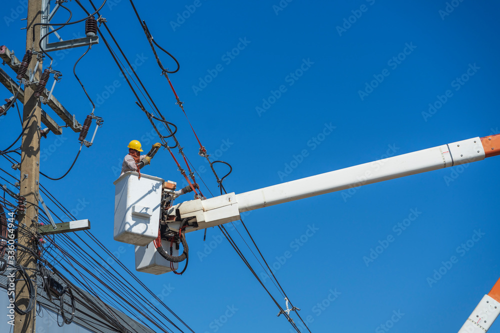 maintenance of electricians work with high voltage electricity on the hydraulic bucket