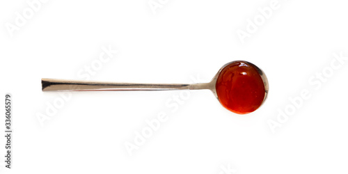 Spoon with sweet chili sauce isolated on white background, top view. Close-up seasoning and dip