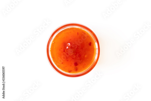 Sweet chili sauce in glass bowl isolated on white background, above. Seasoning and dip