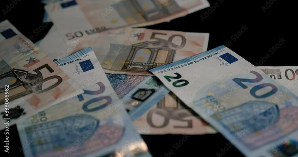 Real Mixed Euro Banknotes Flying in a Black Background Real Mixed Euro Banknotes Flying in a Black Background