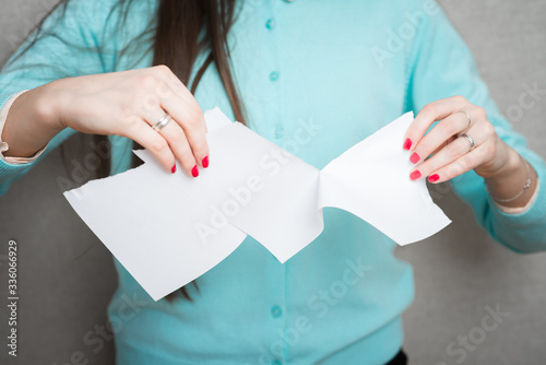 Breaking contract. Furious young woman tearing up paper