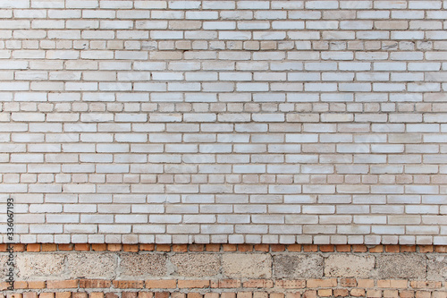 The wall is made of gray silicate bricks. Brickwork on the construction site of the house. Abstract construction texture.