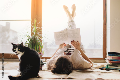 Coronavirus. Quarantine. Online training education and freelance work. Cat and girl studying remotely. Coronavirus pandemic world. social distancing, work from home, stay home concept, home office.