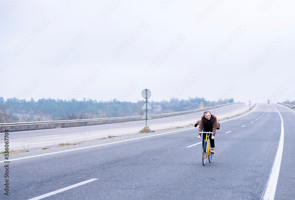 Obraz premium Cyclist riding a bike on an open road
