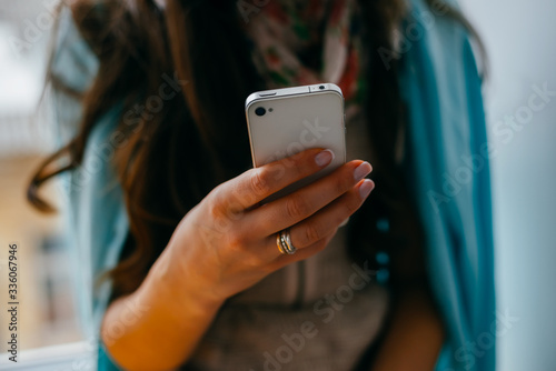 Young woman dials number on mobile phone