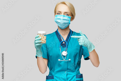 medical doctor nurse woman wearing protective mask and rubber or latex gloves - holding pills