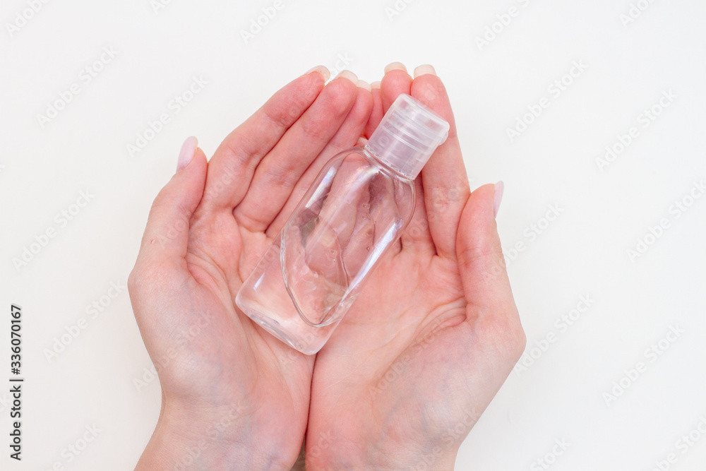 bottle with antibacterial antiseptic gel in hand isolated on white