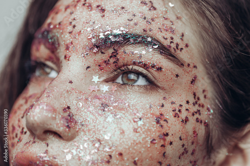 Beauty glitter on woman face. Creative make up.