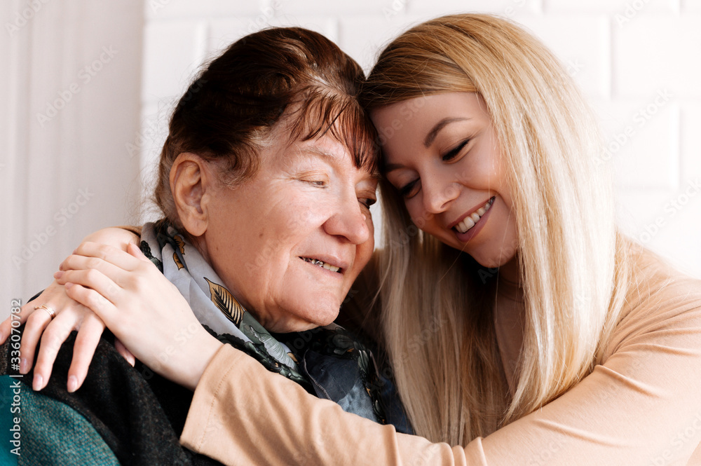 Happy old grandmother hugging grandchild girl looking at camera, smiling mature mother, headshot portrait Happy old grandmother hugging grandchild girl looking at camera, smiling mature mother, headshot portrait