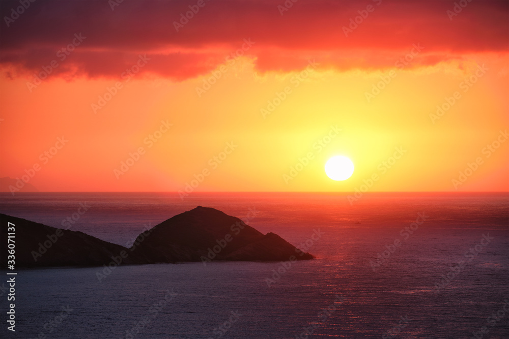 Sea sunset. Seascape sunset with island. Sun setting down in sea. Crete island, Greece