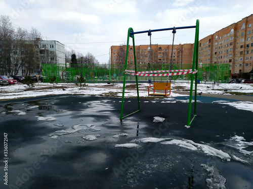 Stay home concept.Empty Swings In Playground closeup