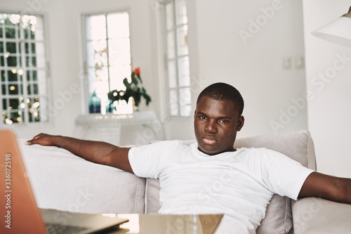 man sitting on sofa