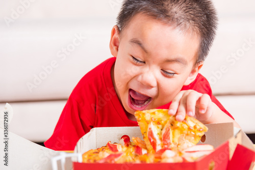 Little Child enjoying holding Delivery Pizza pepperoni  cheese