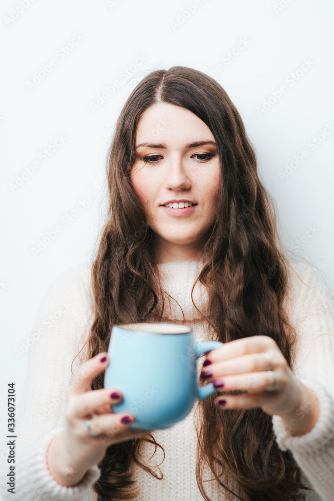 brunette girl drinking coffee or tea on a white background brunette girl drinking coffee or tea on a white background