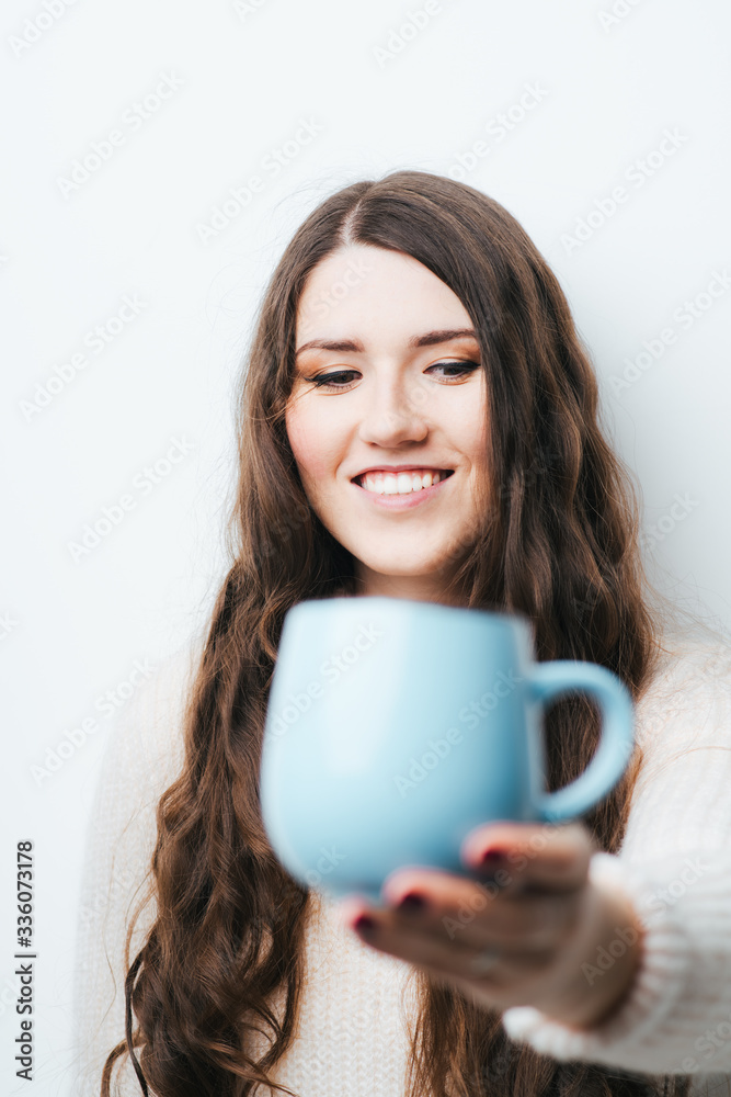 brunette girl drinking coffee or tea on a white background brunette girl drinking coffee or tea on a white background