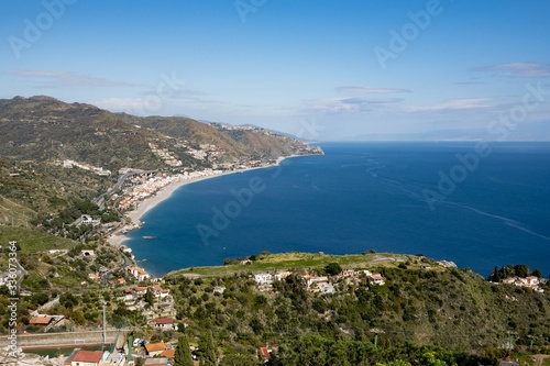 Northeastern landscape of Taormina city, Sicily with a coastline, blue sea and Letojanni town