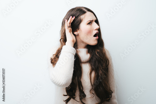 beautiful long-haired girl overhears on a white background