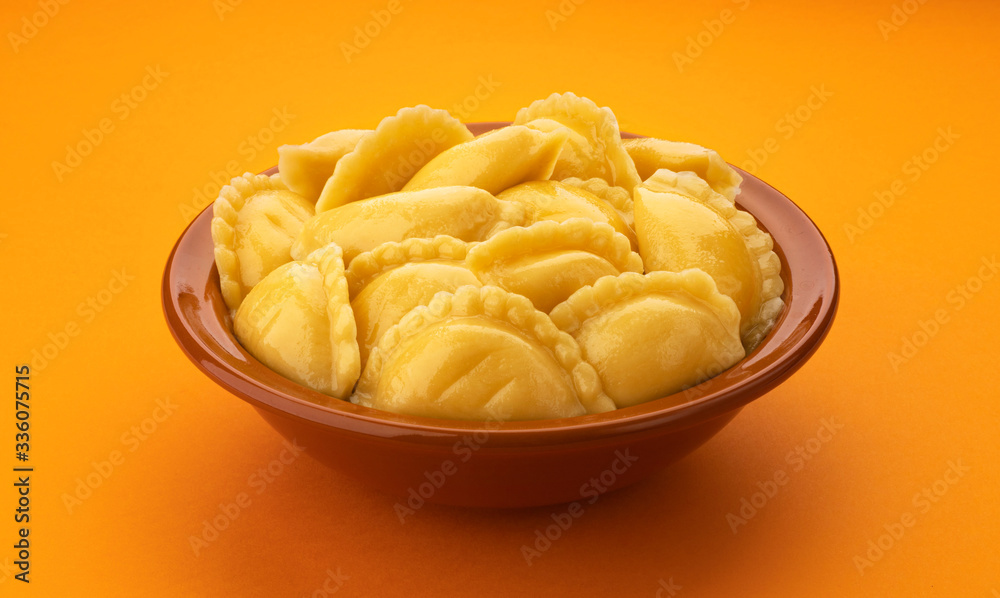 Filled dumplings, homemade russian vareniki, pelmeni in bowl Filled dumplings, homemade russian vareniki, pelmeni in bowl