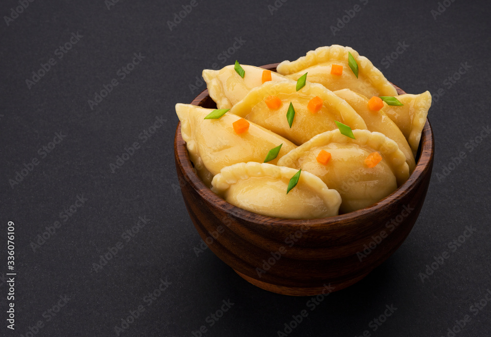 Dumplings, russian vareniki, pelmeni on black background Dumplings, russian vareniki, pelmeni on black background