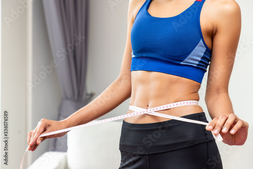 Attractive female woman torso with measuring tape, weight loss and dieting concept photo