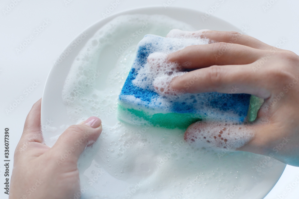 Fototapeta premium washing dishes, a plate in foam