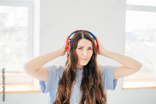 girl with headphones on the window background