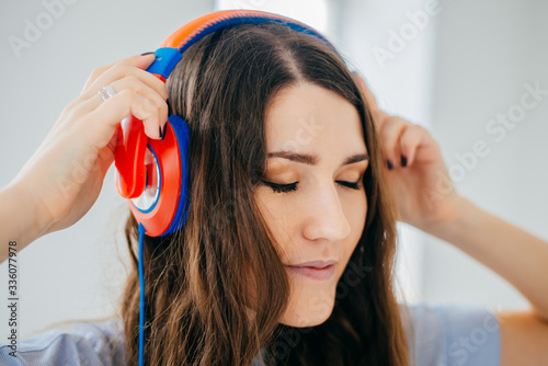 girl with headphones on the window background