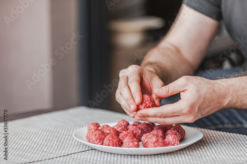 Man hands preparing meatballs with raw mincemeat