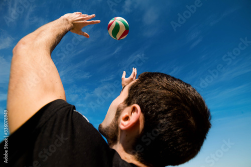young man playing beach volleyball © Image'in