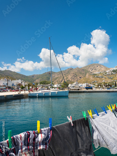 drying clothes on the rope and view to marine and yachts on greek island in summer day
