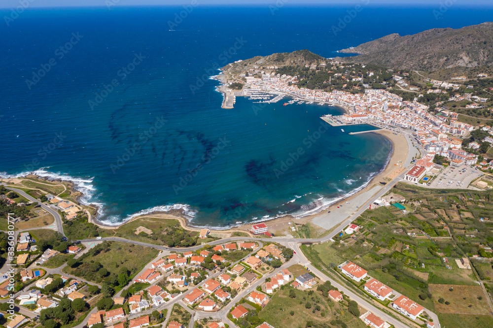 Fototapeta premium Aerial drone photo of a coastal city in Spain on a beautiful sunny day with a beautiful blue sea