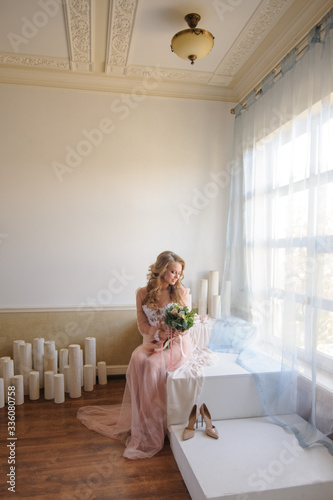 Morning of a beautiful young bride in a boudoir dress.