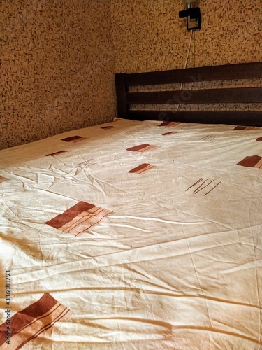 Fotografie Made-up wooden bed in bedroom