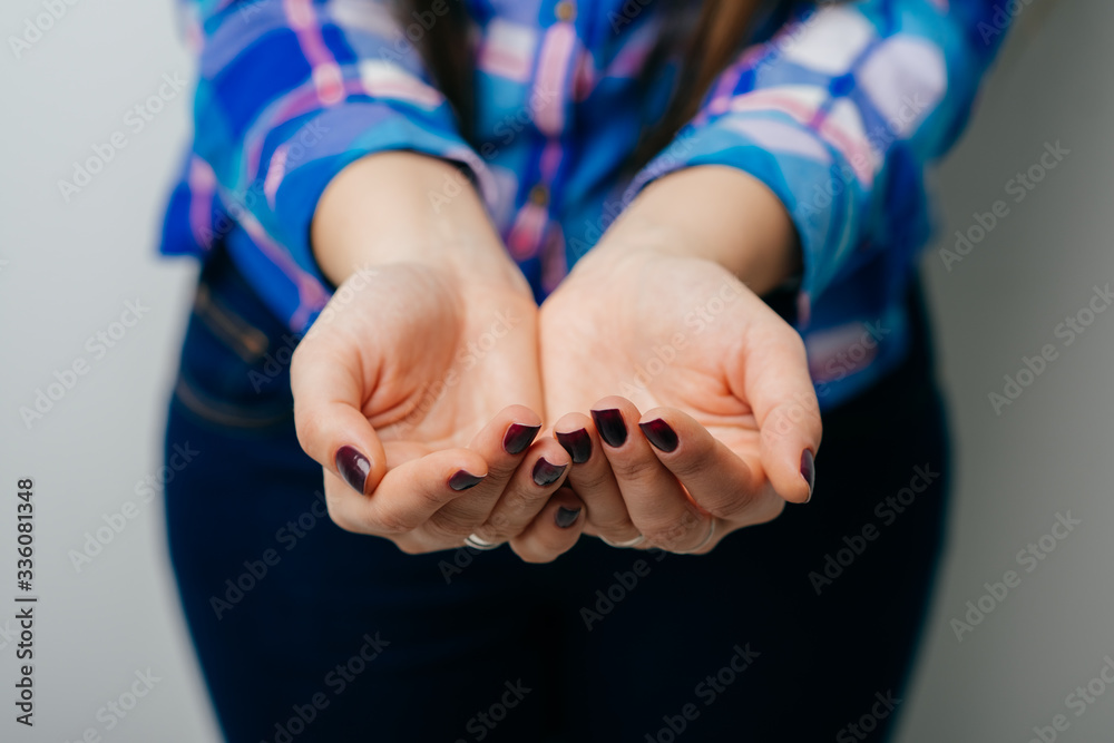 Fototapeta premium The open hands of woman. Your objects here. Hands cupped together against white