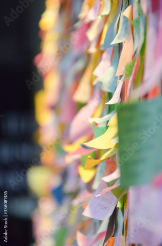 A conceptual picture of a public wall with a hundred of notes hoping to heal the people of the world of COVID 19 disease.