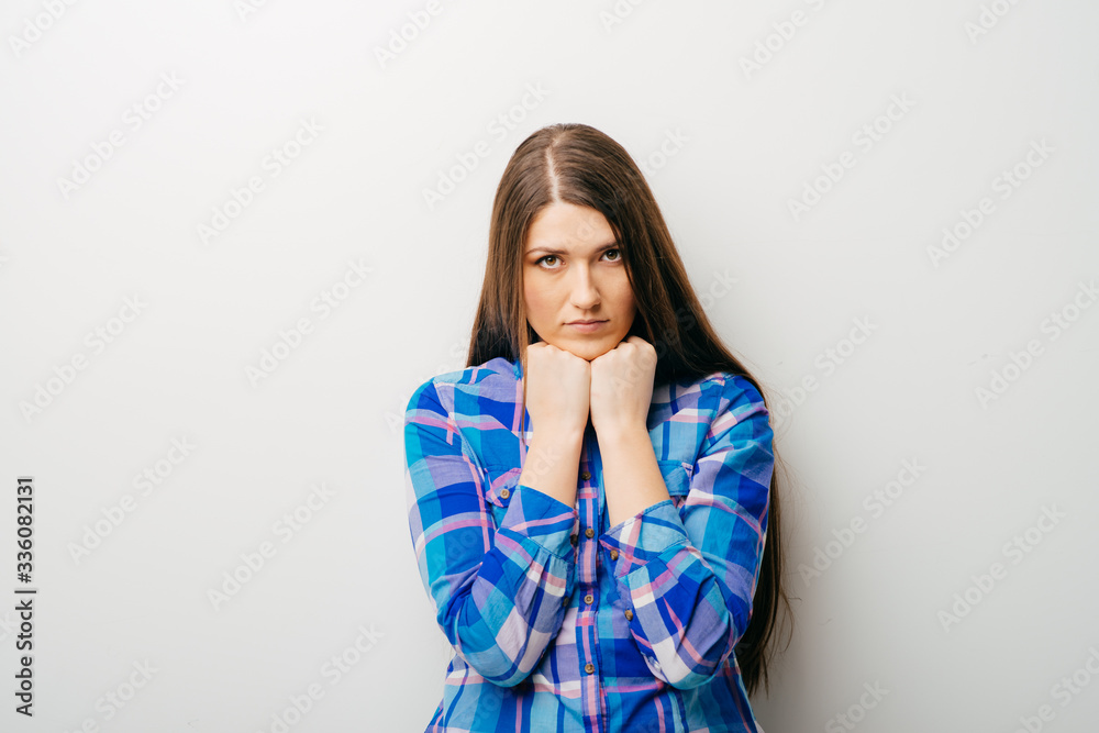 girl on a white background props chin fist girl on a white background props chin fist