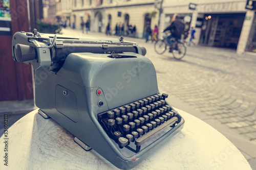 Vintage typewriter at the entrance to boutique on a tourist packed street. photo