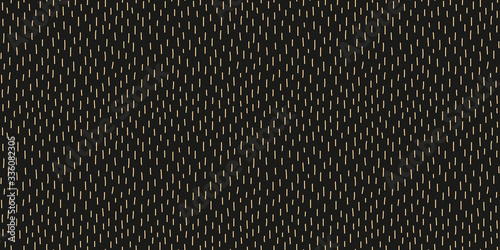 Abstract random short lines seamless repeat pattern yellow beige on black background for fabric surface design