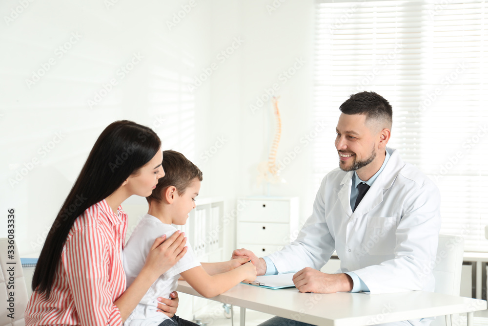 Little boy with mother visiting orthopedist at clinic Little boy with mother visiting orthopedist at clinic
