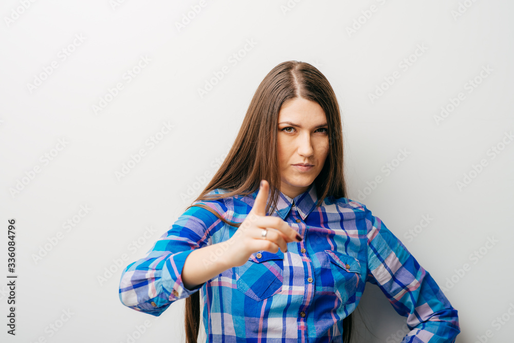 on white background young girl shows the index finger up on white background young girl shows the index finger up