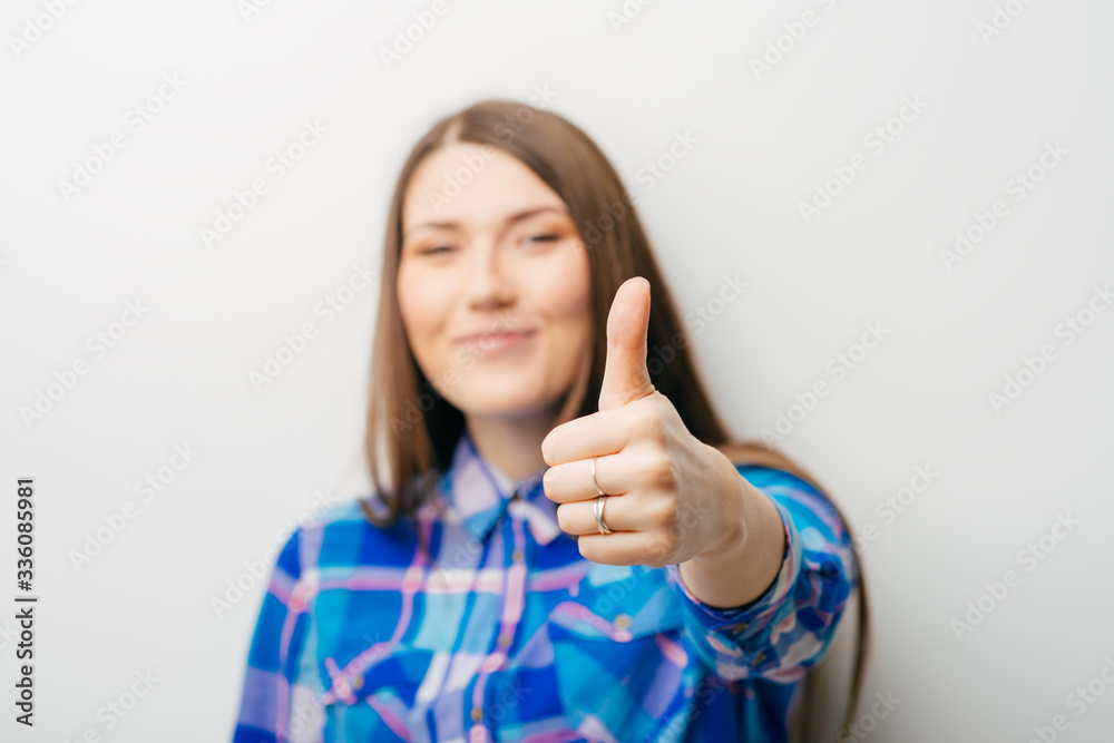 beautiful long-haired girl showing ok thumb isolated on white background beautiful long-haired girl showing ok thumb isolated on white background